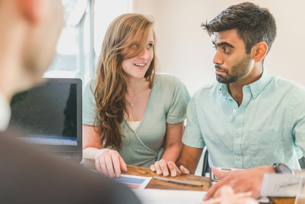 Two colleagues discuss business strategy during a meeting, focusing on teamwork and collaboration.