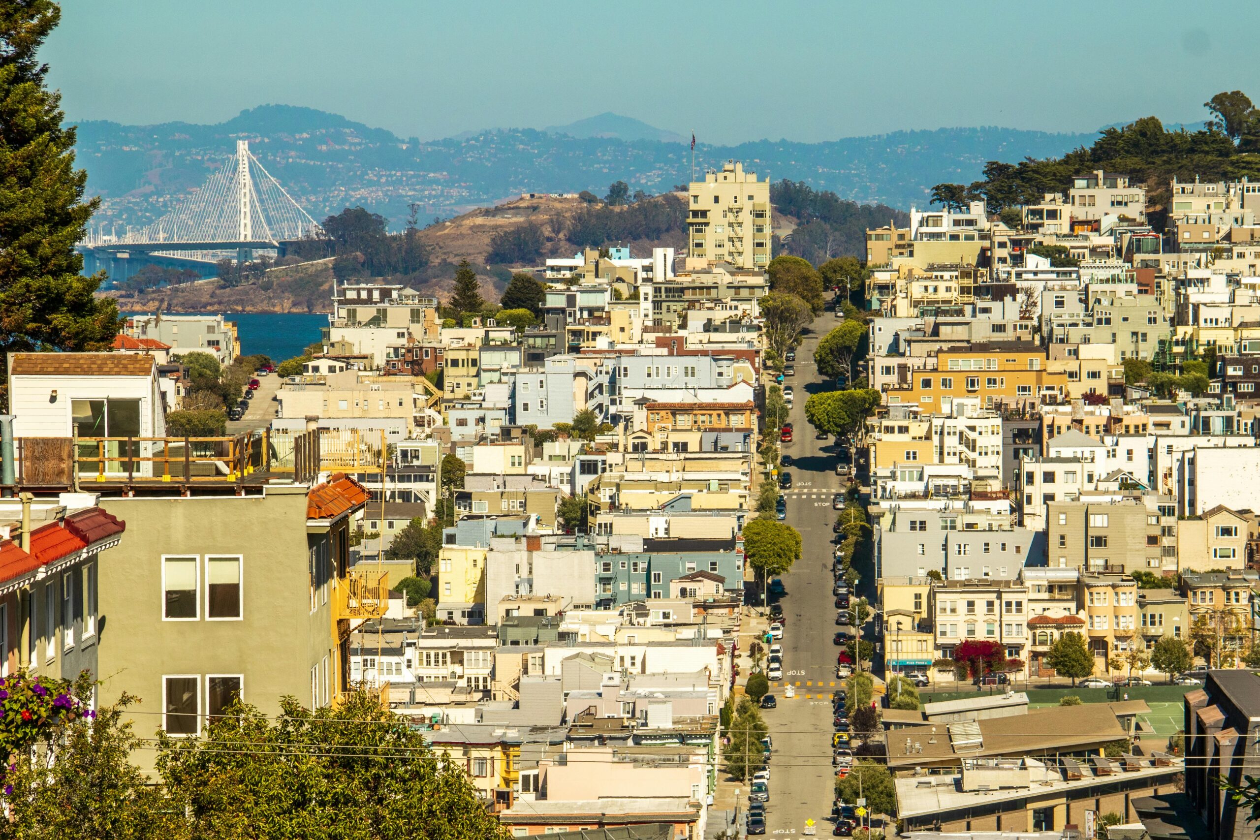 A vibrant view of San Francisco's urban landscape with the Bay Bridge in the background.