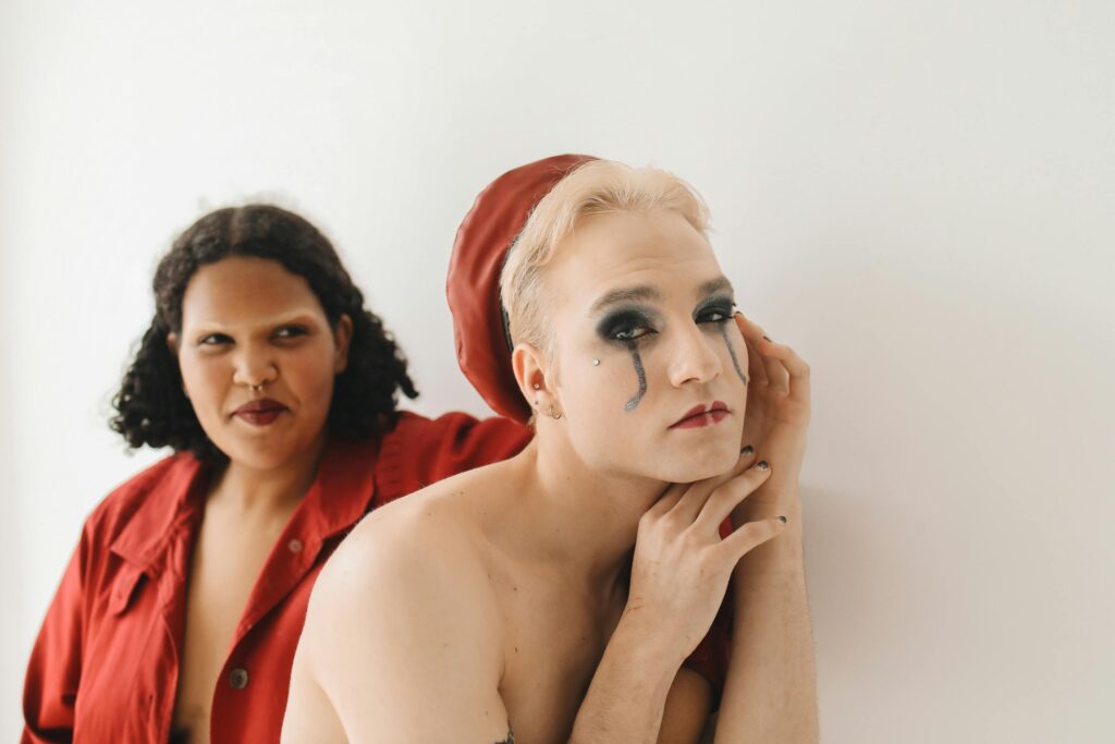 An artistic portrait showcasing diverse gender identities with expressive makeup.